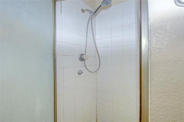 bathroom with a shower with door