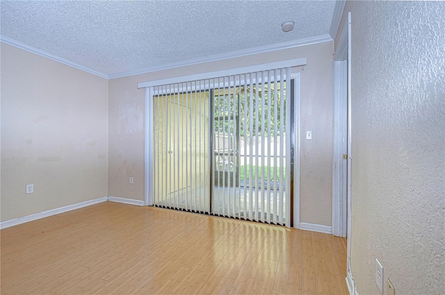 unfurnished room with a textured ceiling, light wood-type flooring, and crown molding