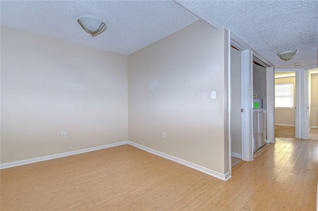 unfurnished room featuring light hardwood / wood-style flooring and a textured ceiling