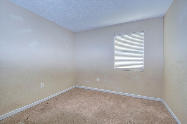 empty room featuring carpet flooring and a textured ceiling