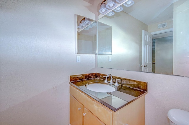 bathroom with vanity and toilet