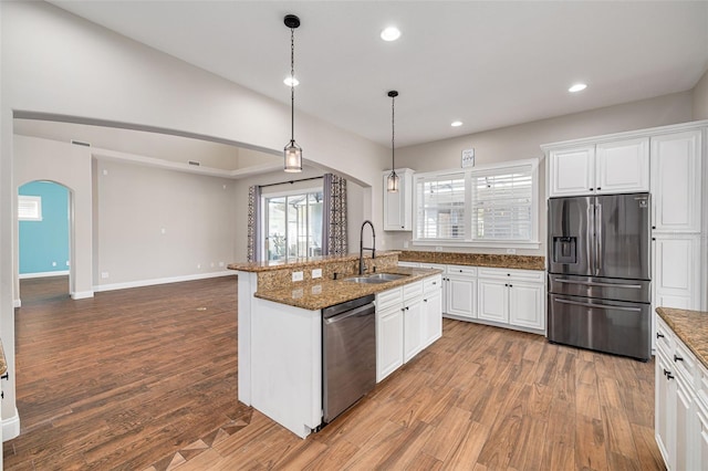 kitchen featuring white cabinetry, wood-type flooring, and stainless steel appliances