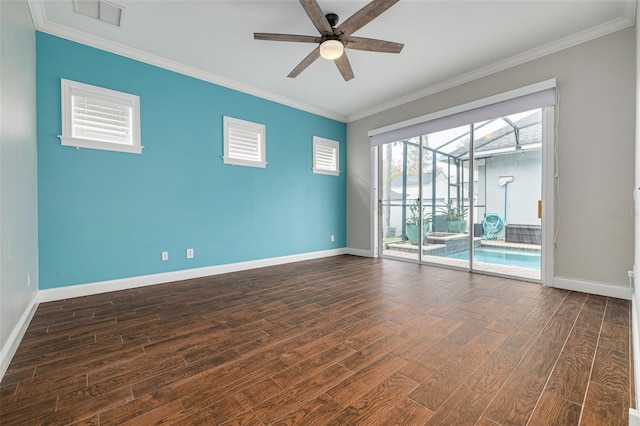 empty room featuring ceiling fan, crown molding, and dark wood-type flooring