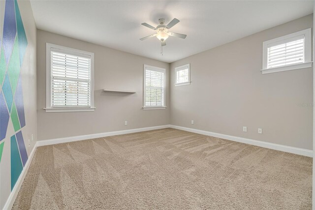 carpeted empty room with ceiling fan