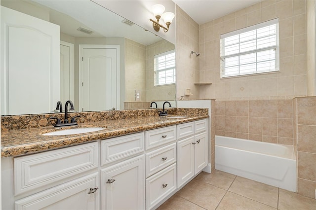 bathroom with tile patterned flooring, vanity, and washtub / shower combination