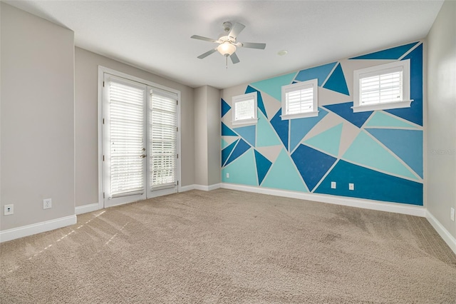 unfurnished room featuring plenty of natural light, ceiling fan, and carpet floors