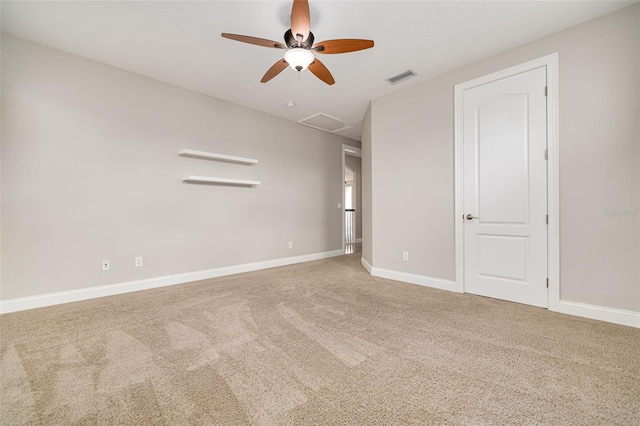 carpeted spare room featuring ceiling fan