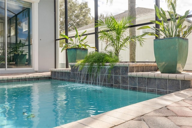 view of swimming pool with pool water feature