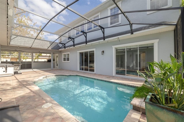 view of swimming pool featuring a patio and glass enclosure