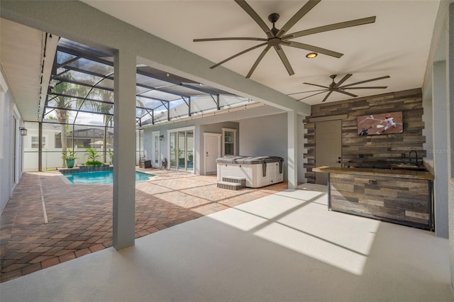 view of patio / terrace with a lanai, ceiling fan, and a swimming pool with hot tub