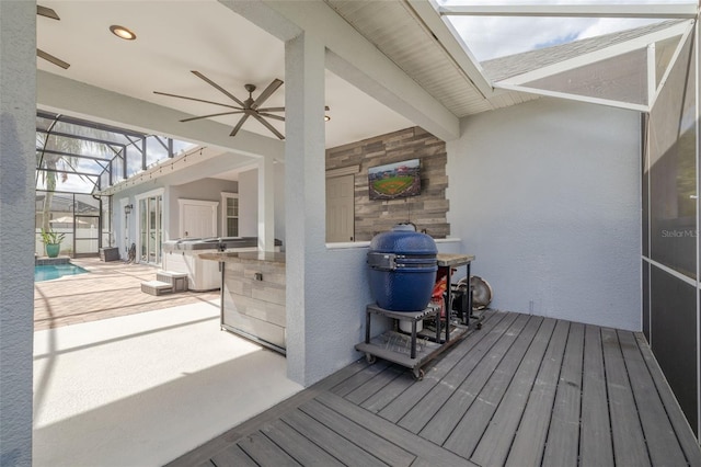 wooden terrace featuring a lanai, a patio area, and ceiling fan