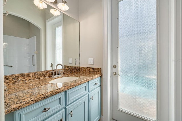 bathroom featuring vanity and a shower