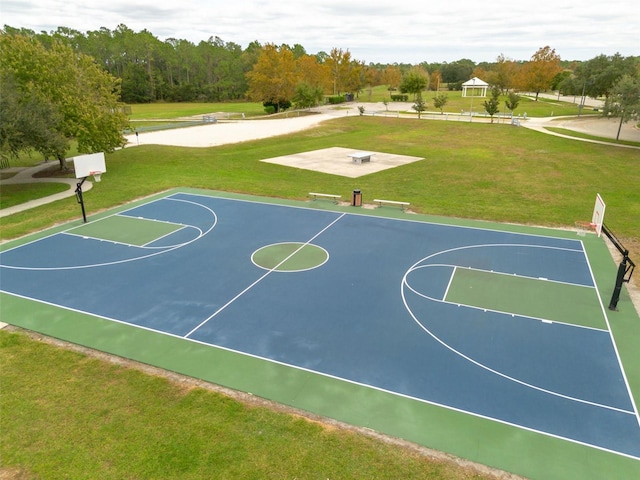 view of sport court with a lawn