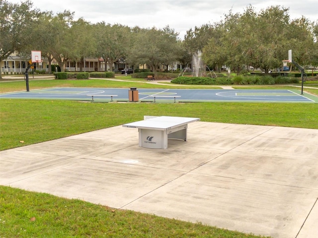 view of basketball court featuring a yard