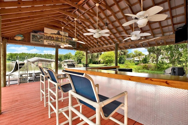 wooden terrace featuring ceiling fan and outdoor dry bar