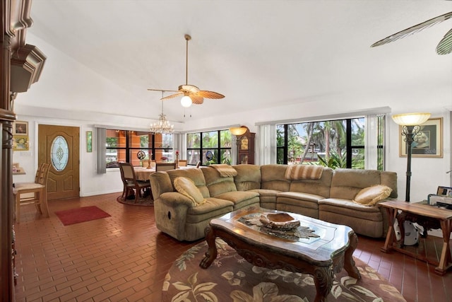 living room featuring ceiling fan with notable chandelier, brick floor, and lofted ceiling