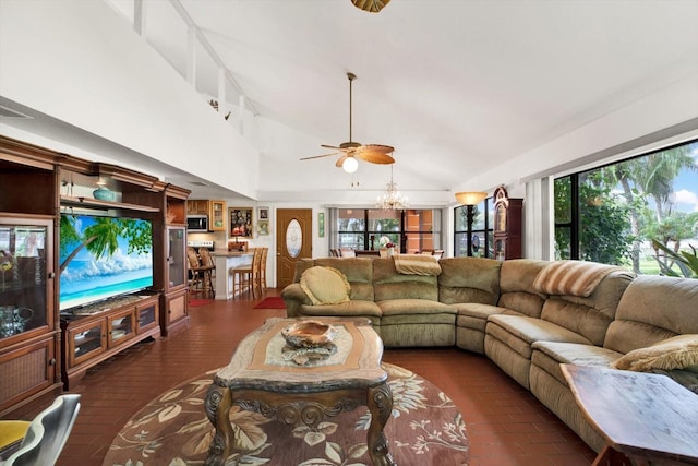 living room with high vaulted ceiling and a chandelier