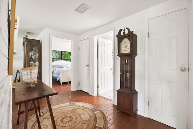 interior space featuring brick floor and visible vents