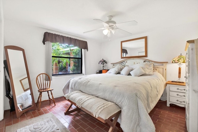 bedroom with brick floor and a ceiling fan