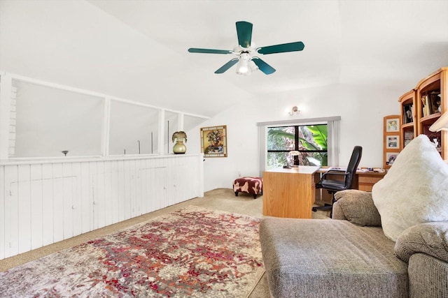 carpeted office space featuring lofted ceiling and a ceiling fan