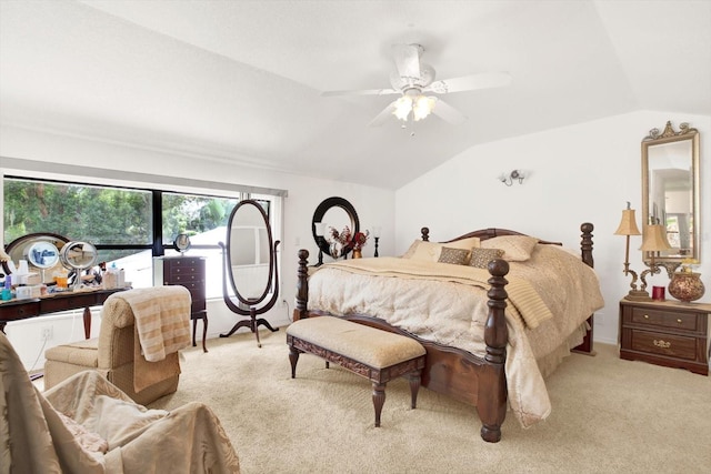 bedroom with lofted ceiling, a ceiling fan, and light colored carpet