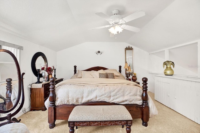 bedroom with lofted ceiling, a ceiling fan, and light colored carpet