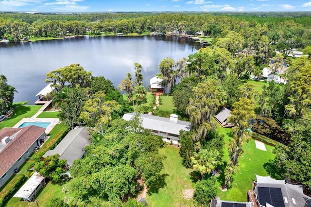 aerial view with a water view and a forest view