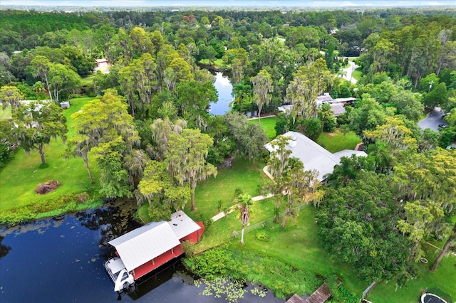 drone / aerial view featuring a water view and a forest view