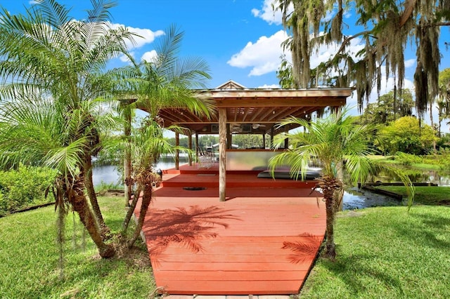 exterior space featuring a lawn and a water view