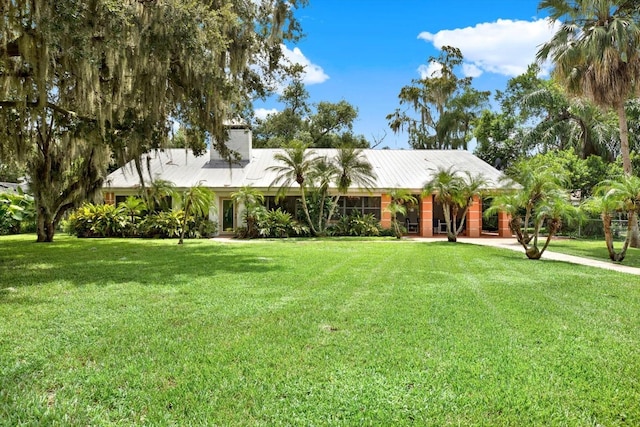 view of front of house featuring a front yard and a chimney