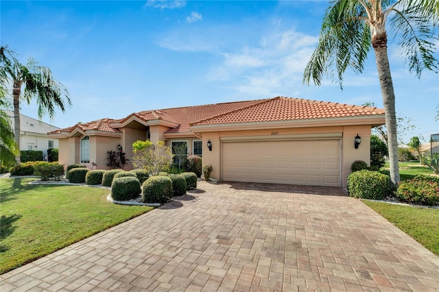 mediterranean / spanish-style home featuring a garage and a front lawn