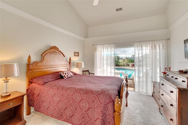 carpeted bedroom with ceiling fan and high vaulted ceiling