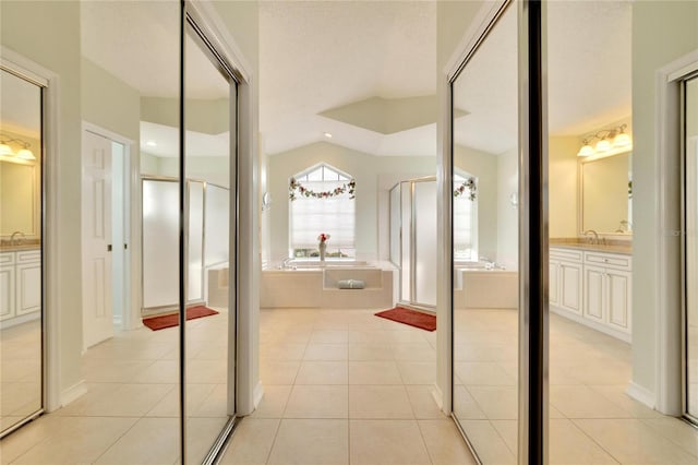 bathroom with plus walk in shower, tile patterned floors, vanity, and vaulted ceiling