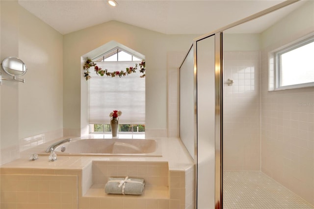 bathroom featuring separate shower and tub and lofted ceiling