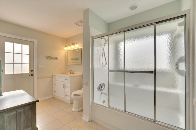 full bathroom with tile patterned flooring, vanity, toilet, and bath / shower combo with glass door