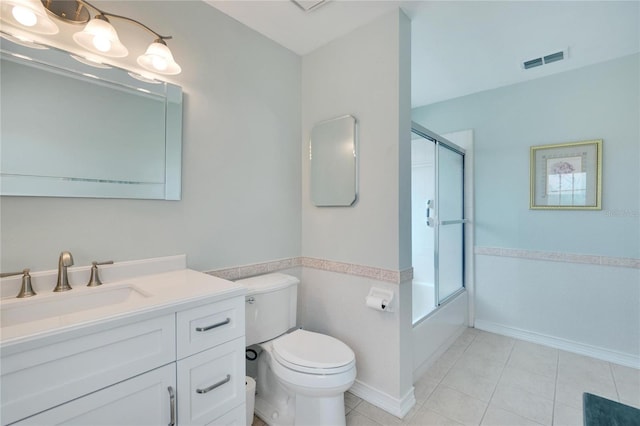 full bathroom featuring tile patterned floors, vanity, toilet, and shower / bath combination with glass door