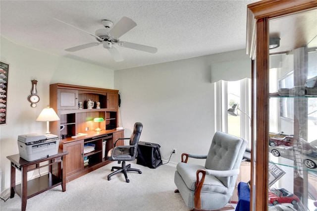 home office with ceiling fan, light colored carpet, and a textured ceiling