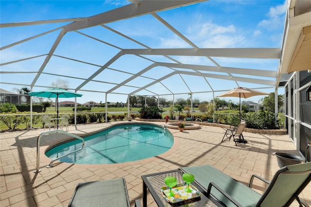 view of swimming pool with a patio and a lanai