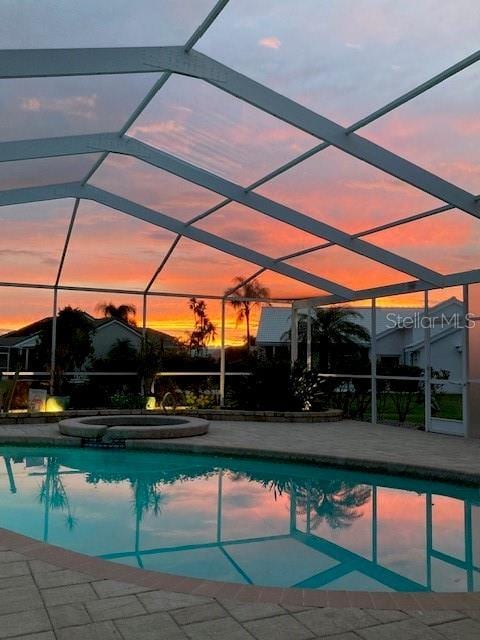 pool at dusk with glass enclosure