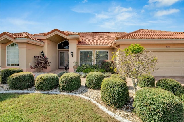 mediterranean / spanish-style home featuring a garage