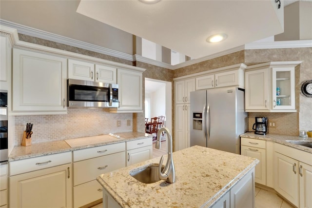 kitchen with decorative backsplash, light stone countertops, sink, and appliances with stainless steel finishes