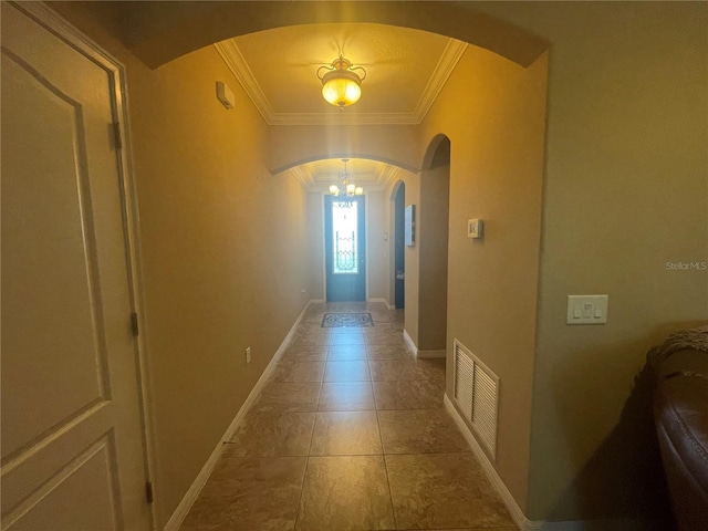 hallway with tile patterned flooring and ornamental molding