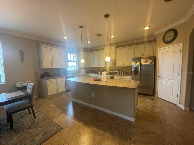 kitchen featuring white cabinetry, appliances with stainless steel finishes, hanging light fixtures, and a kitchen island