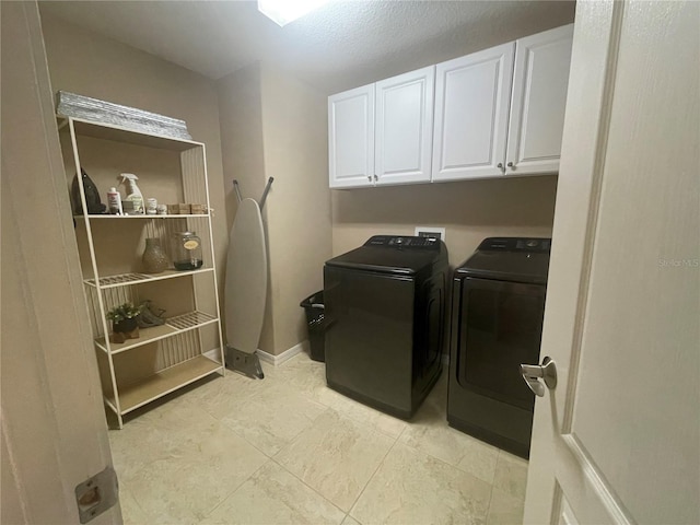 washroom featuring cabinets and washer and dryer