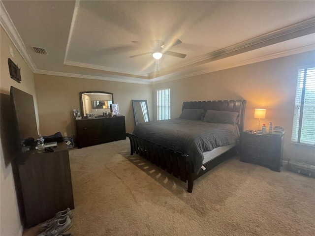 bedroom featuring carpet flooring, ornamental molding, ceiling fan, and a tray ceiling