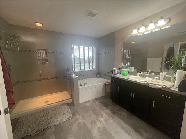 bathroom with vanity and separate shower and tub