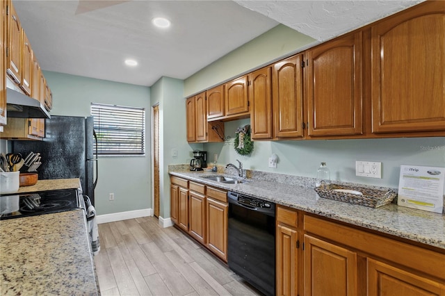 19807 Gulf Blvd Unit 128, Indian Shores, FL 33785 - kitchen with dishwasher, under cabinet range hood, a sink, light wood finished floors, and brown cabinetry