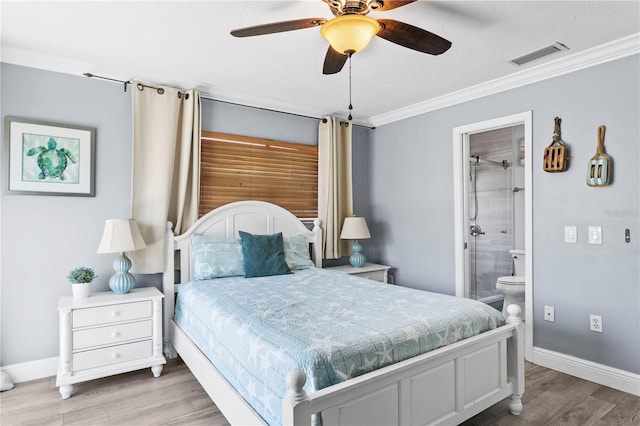 19807 Gulf Blvd Unit 128, Indian Shores, FL 33785 - bedroom with ornamental molding, wood finished floors, baseboards, ensuite bath, and a ceiling fan