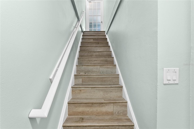 stairway with hardwood / wood-style flooring