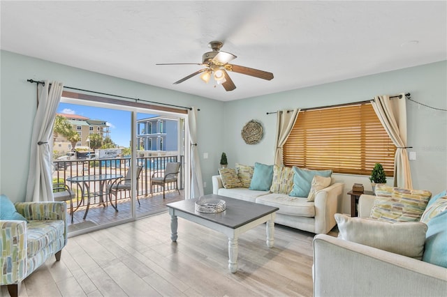 living room featuring ceiling fan and light hardwood / wood-style flooring